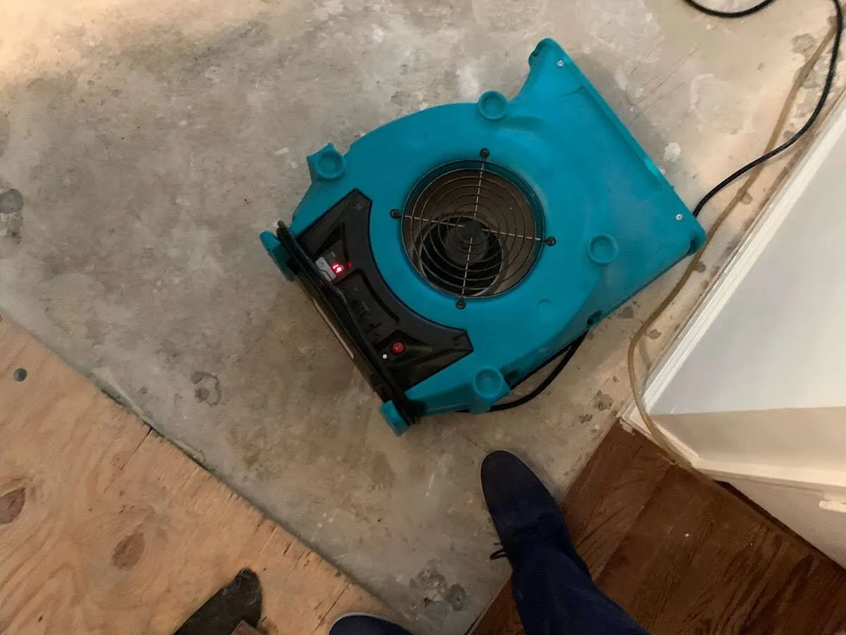 Air mover drying subfloor during Commercial Water Damage Restoration in Muncie